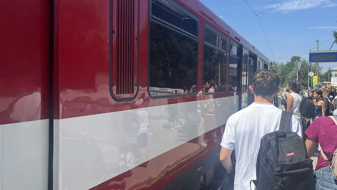Im Bild ist ein Waggon der Lokalbahn in Salzburg zu sehen, die von Salzburg Hauptbahnhof über Anthering, Oberndorf und Bürmoos weiter Richtung Lamprechtshausen fährt.
